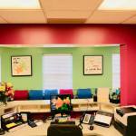 Organized pediatric dental reception desk, looking out into a colorful and clean waiting room in Florissant MO