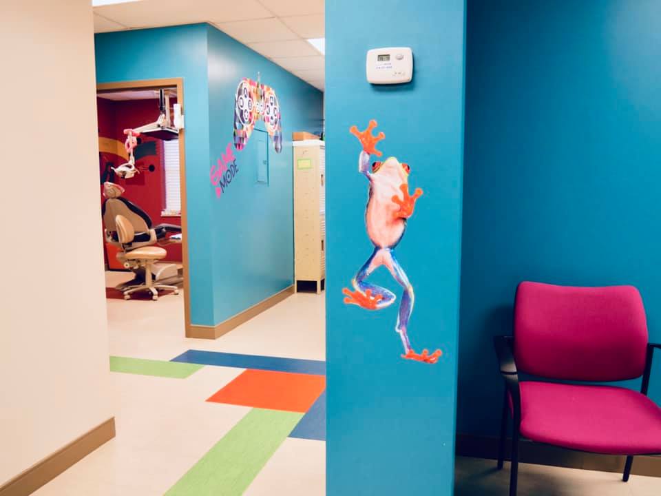 Clean and cheerful pediatric dental practice, with decorative gaming and tree frog wall decals in Florissant MO